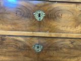 an image of a wooden chest of drawers with knobs