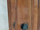 a wooden cabinet with a round hole in it