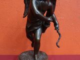 an image of a statue of an angel with a bow on a marble base