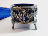 a silver and blue bowl sitting on a table