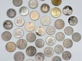 a close up of a bunch of coins on a white surface
