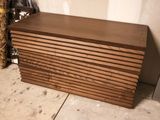 a wooden chest sitting on the floor next to a wall