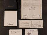 a lot of papers and a watch on the table