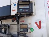 an image of a gas station with a tv on the side