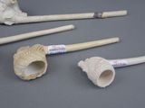four different types of pipes and a pipe holder