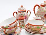 a group of teapots and cups on a white table
