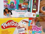 a teddy bear that is sitting next to a box of play - doh