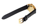 a close up of a watch on a black strap with a gold buckle