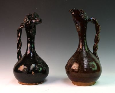 two brown vases sitting side by side on a white surface