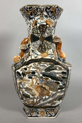 a vase that has a bird on it and a bird on the vase