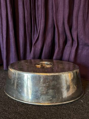 a silver cake pan with a gold ring on top of it
