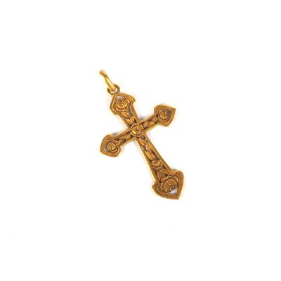 an image of a gold cross pendant on a white background