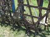 a fence that has a bunch of rusty metal bars attached to it