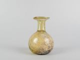 a small glass vase sitting on a white surface