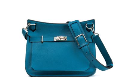 a close up of a blue purse on a white background