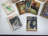 several books on a table with a white table cloth on it