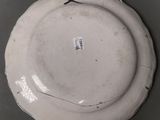 a white plate with a cross on it on a table