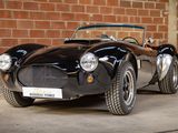 an image of a black sports car parked in front of a brick wall