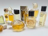 many different types of perfume bottles on a white surface