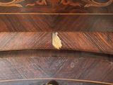 a close up of a wooden table with a drawer on it
