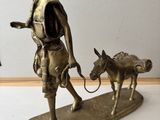 bronze figurine of a man with a dog on a leash