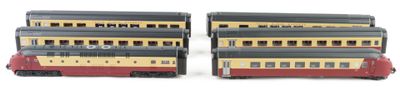 two toy trains sitting next to each other on a white surface