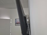 a flat screen tv hanging on a wall in a room