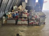a large pile of junk in a garage next to a pile of boxes