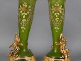 pair of green and gold vases with cherensils and cherensils on them