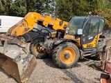 a tractor and a bulldozer in a gravel lot