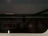 a black stove top with a digital clock on it