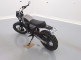 a motorcycle that is sitting on a stand in the middle of a room