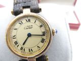 a gold wrist watch with roman numerals on it