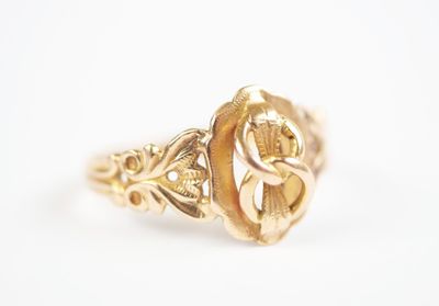 a close up of a gold ring on a white surface