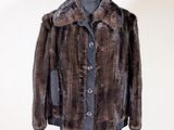 a close up of a fur coat on a mannequin stand