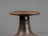a small wooden table with a wooden top and a metal base