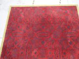a red rug on a white floor with a yellow border