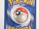a close up of a pokemon card on a white surface