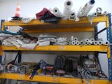 a yellow shelf with many different types of tools on it
