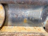 a close up of a rusted metal object with a hole in it