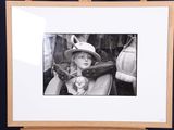 black and white photograph of a child in a chair with a hat on