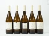 quatre bouteilles de vin sont alignées sur une table