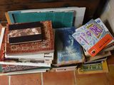 many books stacked on top of each other on the floor