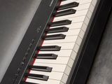 a black piano with white and red keys on it
