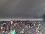 a lot of jewelry that is laying out on the table