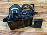 a camera that is sitting on a table next to a battery