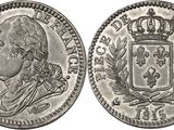 a silver coin with a crown on top of it