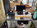 a desk with a laptop and a printer on top of it