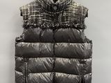 a close up of a black and white vest hanging on a wall