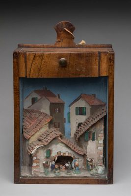 an image of a wooden box with a picture of a village inside of it